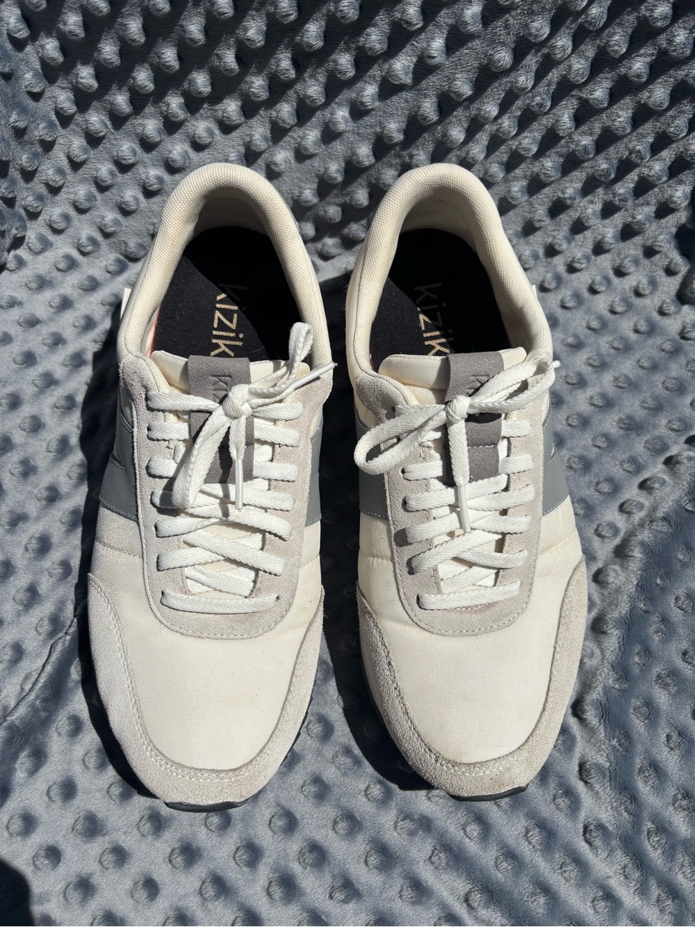 Kizik Milan, a hands-free sneaker in grey and beige.